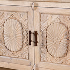 Close up image of a hand-carved mango wood console table Zahira with 2 drawers and 4 doors in a natural finish. Elegant living room furniture piece with artistic detailing and practical storage.