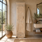 Lifestyle image of a Zaina hand carved bleached reclaimed wood cabinet with floral carved doors 221cm