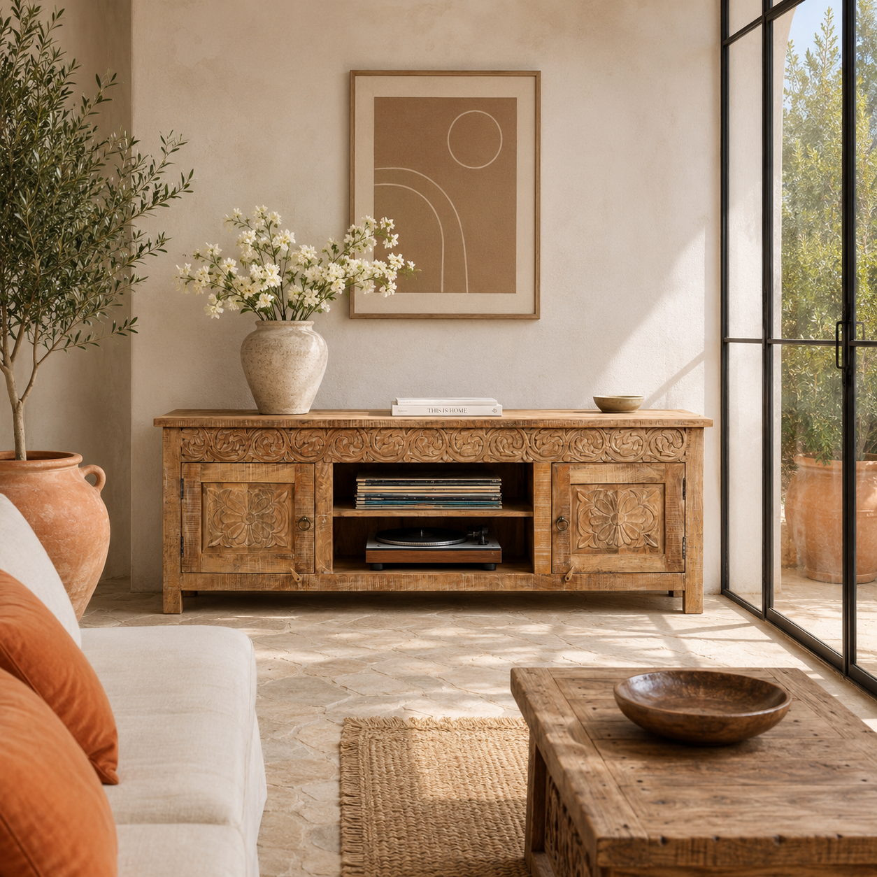 Lifestyle image of a Zarina hand carved mango wood TV unit with floral carved doors 180cm