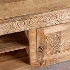 Close up image of a Zarina hand carved mango wood TV unit with floral carved doors 180cm