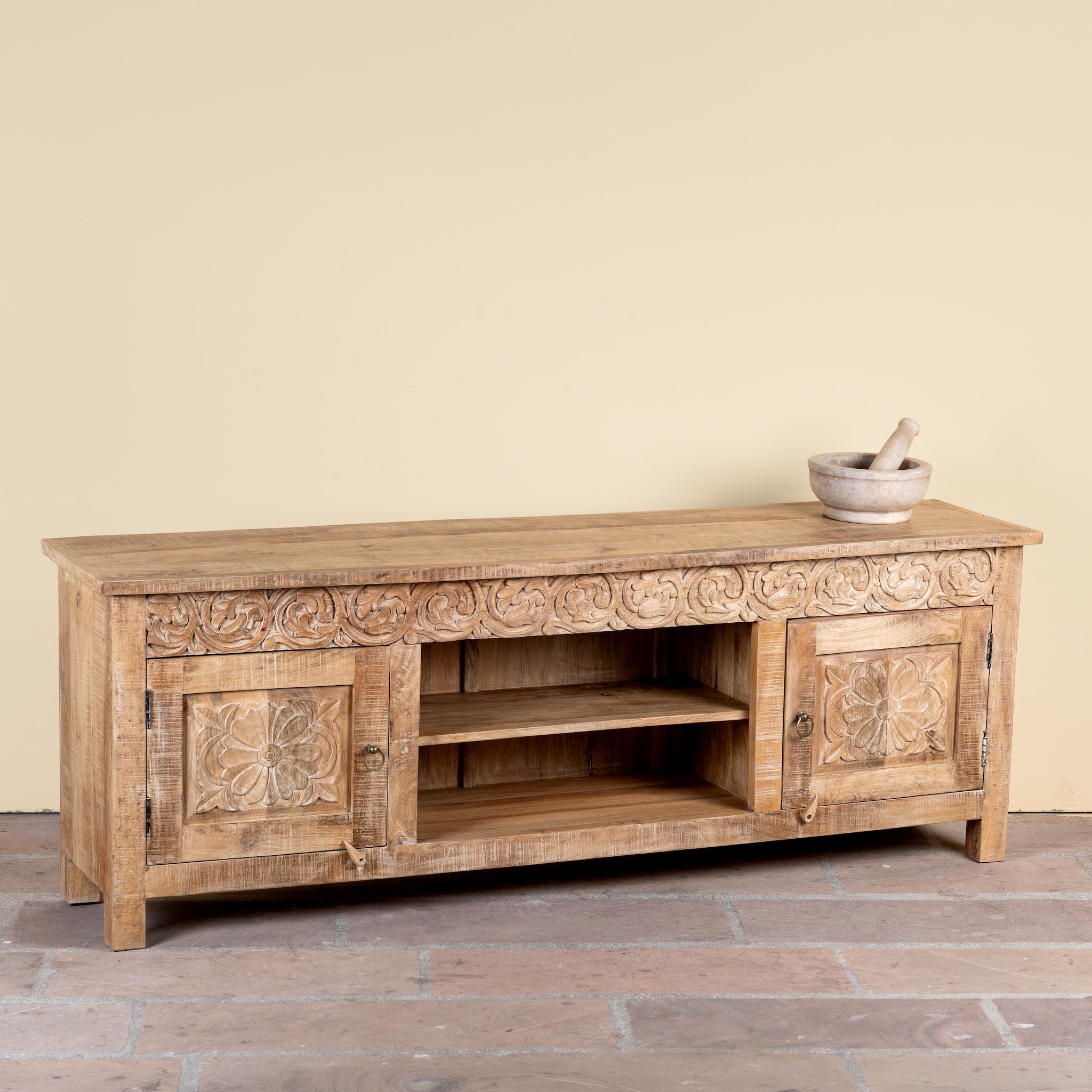 Side angle image of a Zarina hand carved mango wood TV unit with floral carved doors 180cm