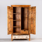 Image showing inner layout with drawers and shelfs of a hand-carved mango wood wardrobe with whitewashed floral motifs – Zashil by Om Home & Garden, a Mediterranean-inspired piece of carved wooden furniture.