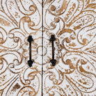 Close up image of a hand-carved mango wood wardrobe with whitewashed floral motifs – Zashil by Om Home & Garden, a Mediterranean-inspired piece of carved wooden furniture.