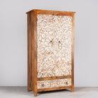 Side angle image of a hand-carved mango wood wardrobe with whitewashed floral motifs – Zashil by Om Home & Garden, a Mediterranean-inspired piece of carved wooden furniture.