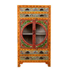 White background picture of a hand-painted showcase cabinet made from mango wood, featuring a circular glass-front display, floral motifs in rich orange, green, and red tones, and five drawers for added storage.

