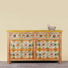 Ziya hand‑painted chest of 8 drawers made from reclaimed wood with floral motifs and iron handles—an artisan piece of painted wooden furniture.