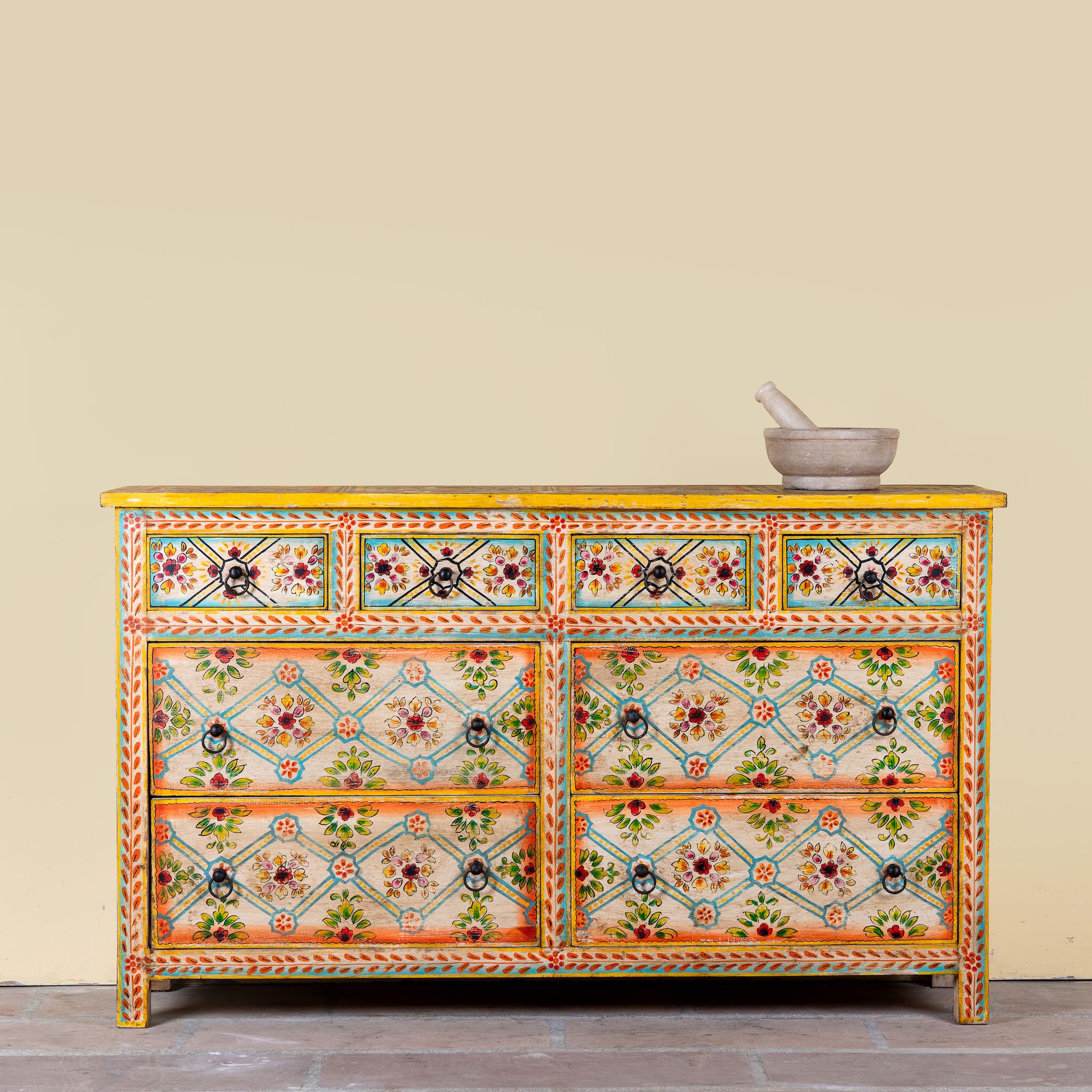 Ziya hand‑painted chest of 8 drawers made from reclaimed wood with floral motifs and iron handles—an artisan piece of painted wooden furniture.