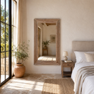 Lifestyle image of a Zunaira reclaimed wood wall mirror with wide natural wooden frame in Ibiza style 140cm