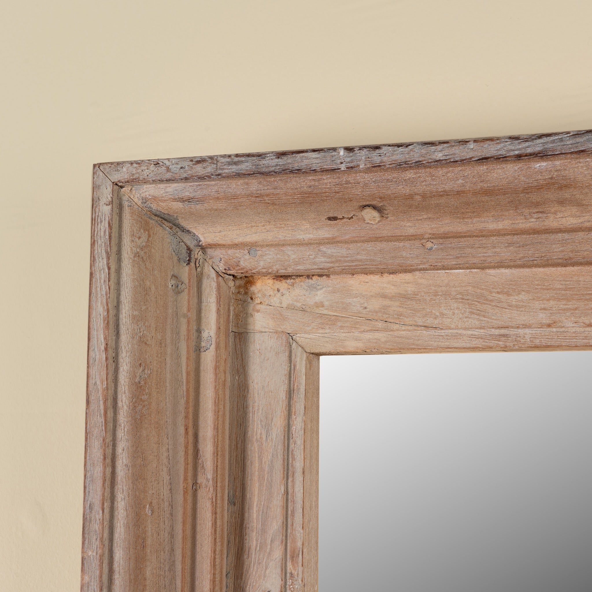 Close up image of a Zunaira reclaimed wood wall mirror with wide natural wooden frame in Ibiza style 140cm