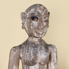 Close up image of an antique Indian wooden temple guardian figure.