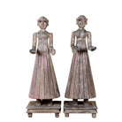 White background image of an antique Indian wooden temple guardian figure with weathered patina, styled beside a black-framed door in a modern living room.