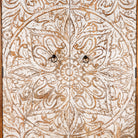 Close up image of a hand-carved mango wood wardrobe with whitewashed floral motifs – Zashil by Om Home & Garden, a Mediterranean-inspired piece of carved wooden furniture.