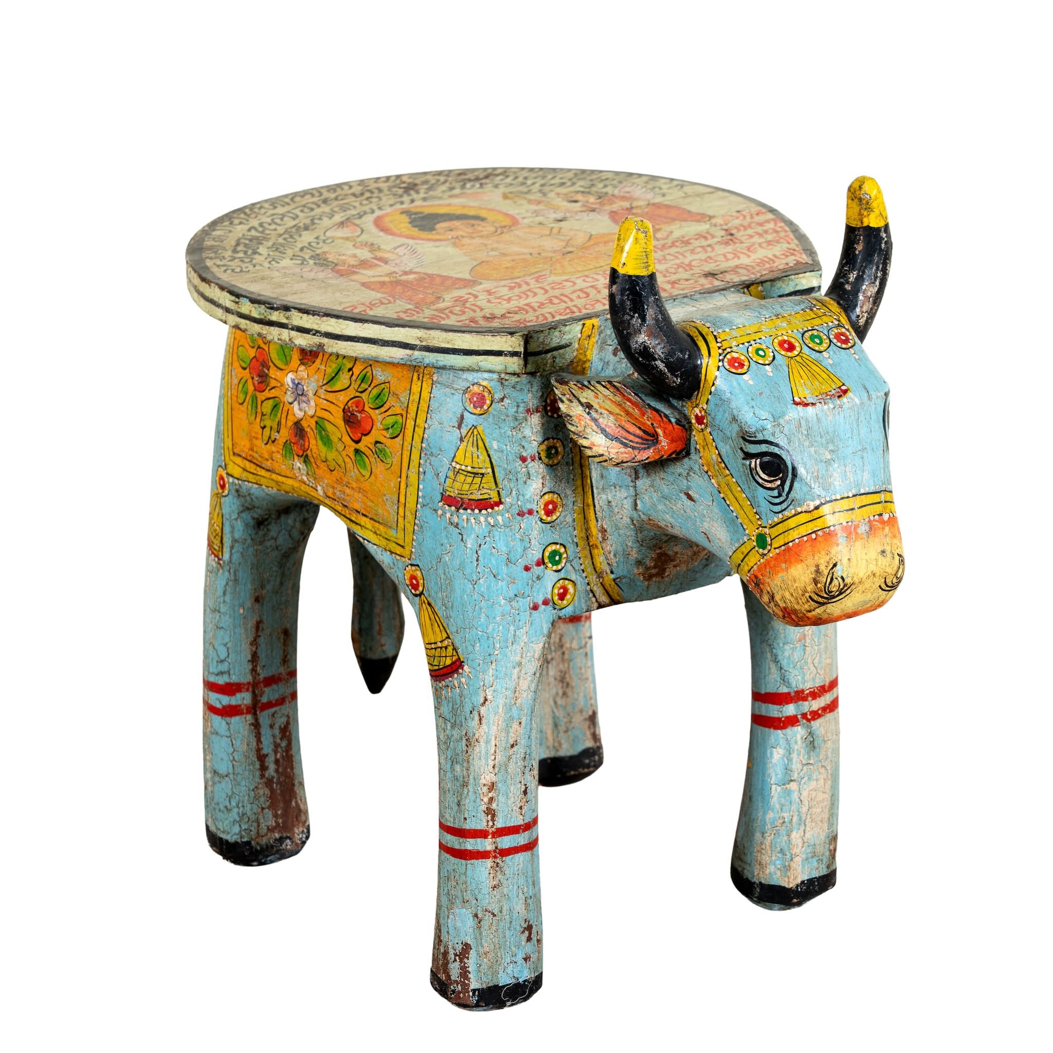 Decorative stool shaped like a bull with colorful patterns on a white background