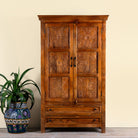 Image of a dark brown mango wood cabinet with hand carvings, 2 drawers and ample storage.