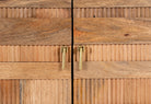 Close up image of a hand-carved mango wood cabinet with 3D line-striped design and natural finish—vintage furniture blending artisanal detail and timeless style.