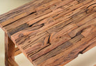 Close up image of a rustic driftwood coffee table made from reclaimed wood with sandblasted finish; sustainable furniture, 100 × 50 × 45 cm.