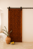Vintage wall panel Nila teak, handcrafted reclaimed wood Indian door with geometric carvings, 100 × 5 × 220 cm.