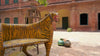 Reel showing two hand-painted tiger chairs made from recycled teak wood with carved tiger motif; ideal for a boho chic living room, 87 × 75 × 96 cm.