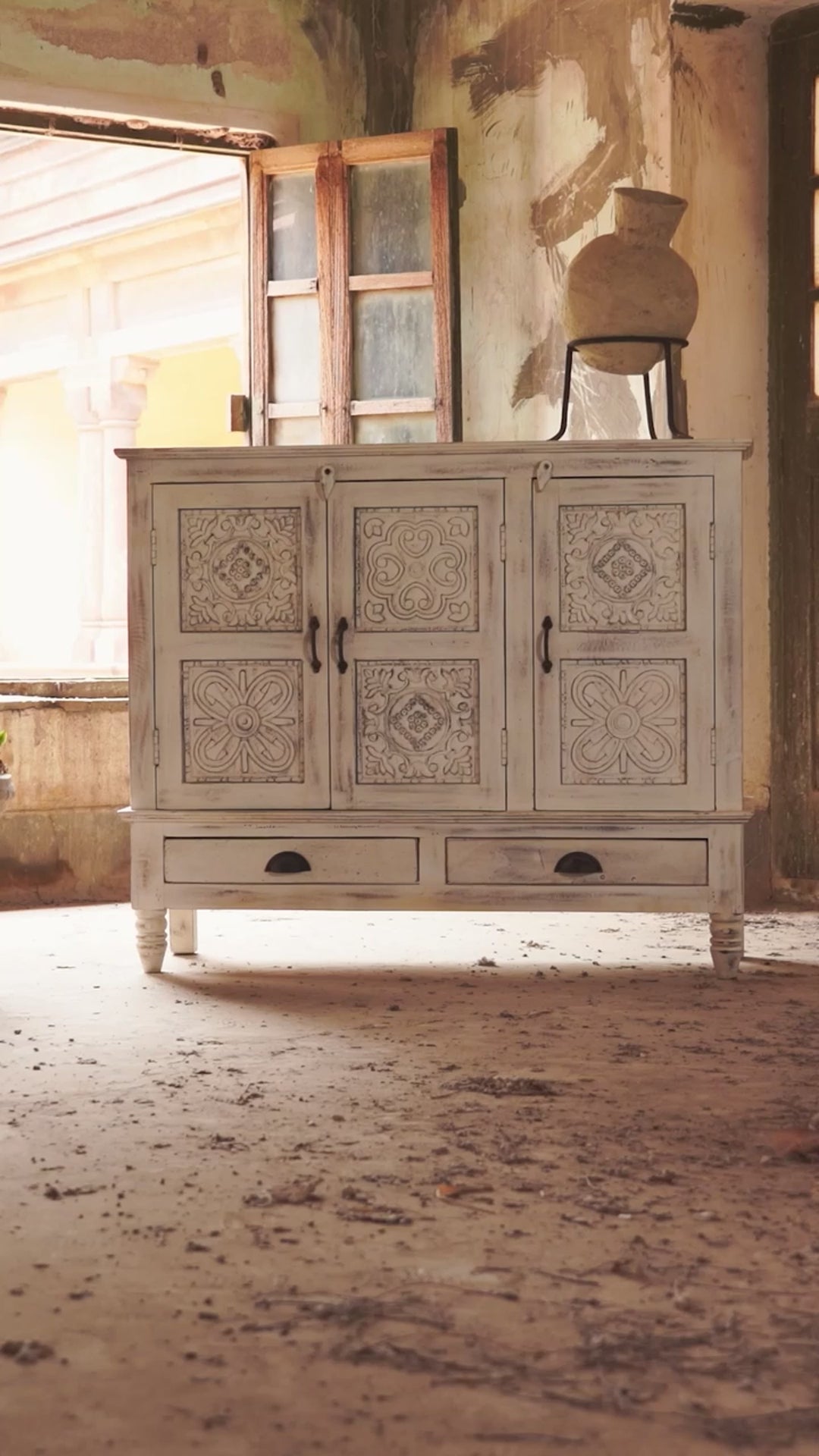 Reel showing a whitewashed hand carved wooden sideboard made from solid mango wood with floral patterns, 3 doors and 2 drawers; artisanal mango wood furniture, 120 × 100 × 40 cm.