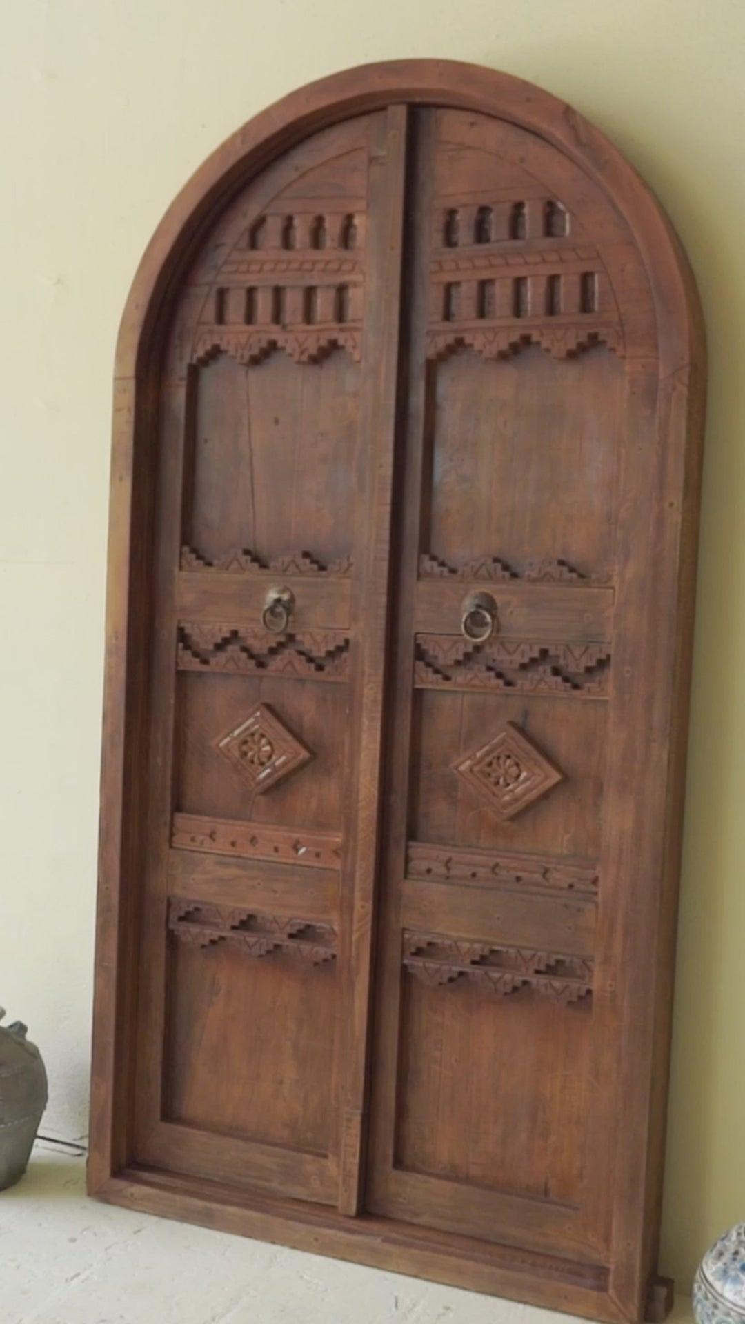 Reel with an arched Moroccan-style door with frame made from reclaimed wood, featuring hand-carved details and a natural aged finish, suitable for wall décor or inbuilt installation.