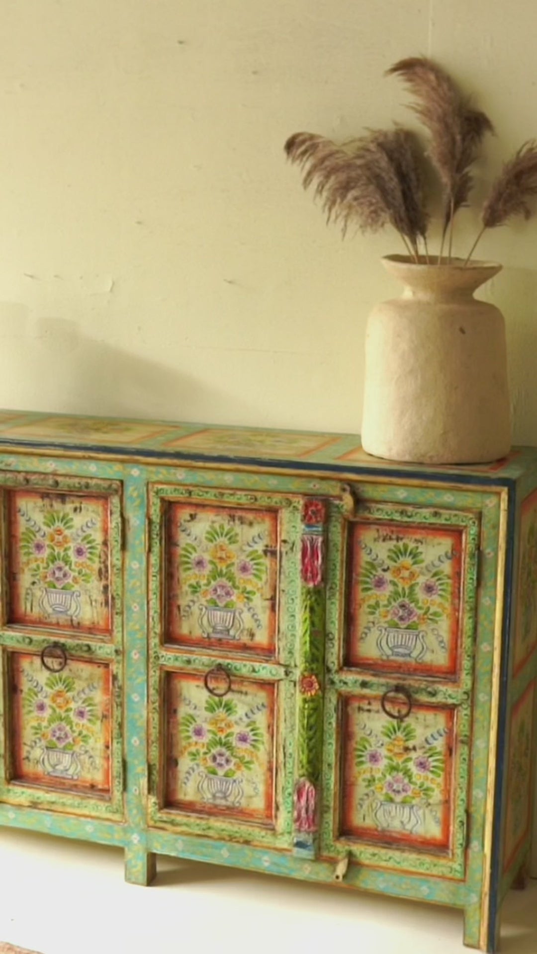 Reel showing a Vintage reclaimed wood sideboard with hand painted floral motifs and distressed finish; artisanal storage furniture for bohemian interiors, 170 × 40 × 104 cm.