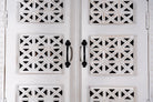 Close up image of a Aesha white washed mango wood cabinet with Oriental hand carved doors 180cm