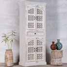 Side angle image of a Aesha white washed mango wood cabinet with Oriental hand carved doors 180cm