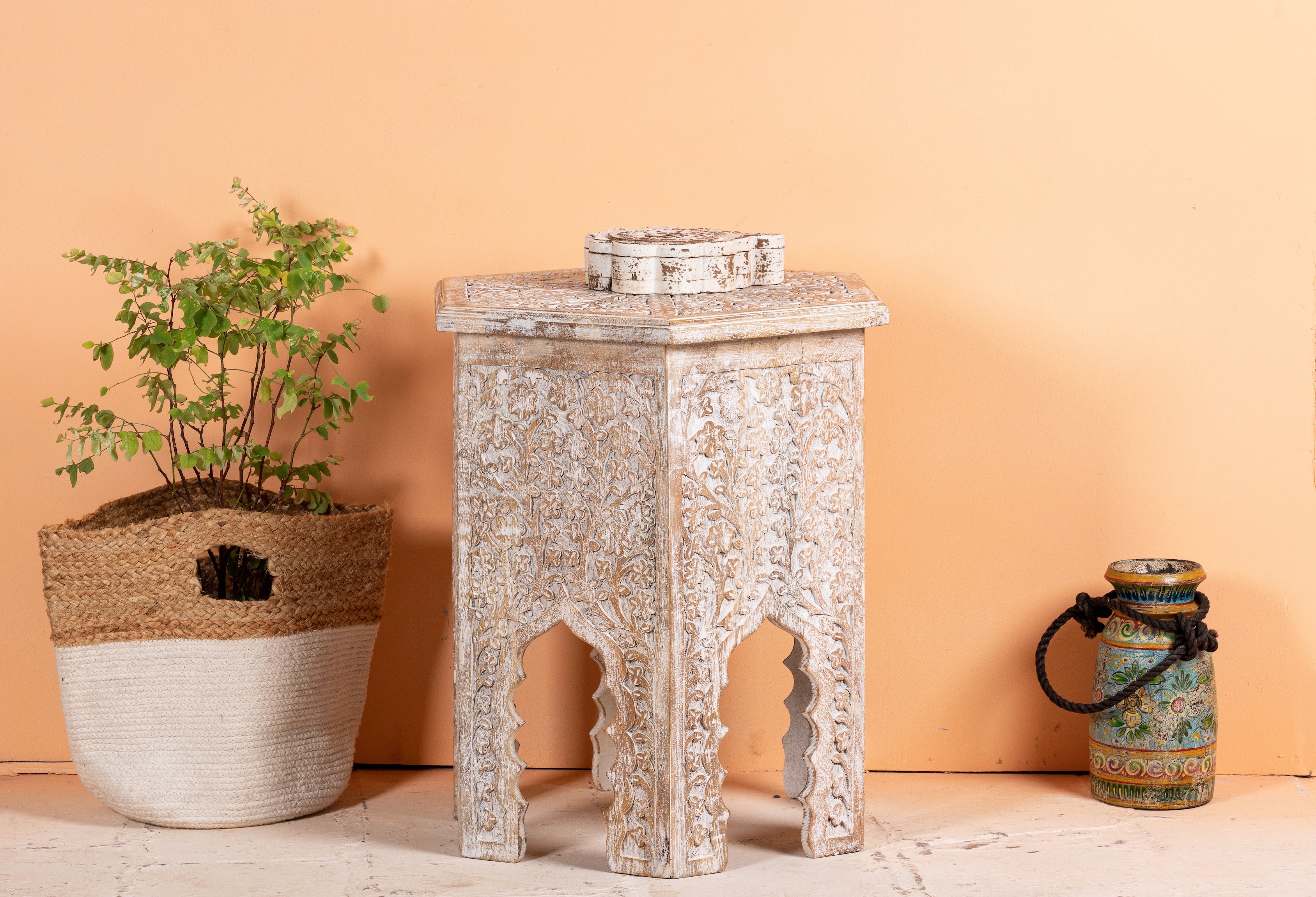 Hand carved white washed vintage coffee table with floral motif.