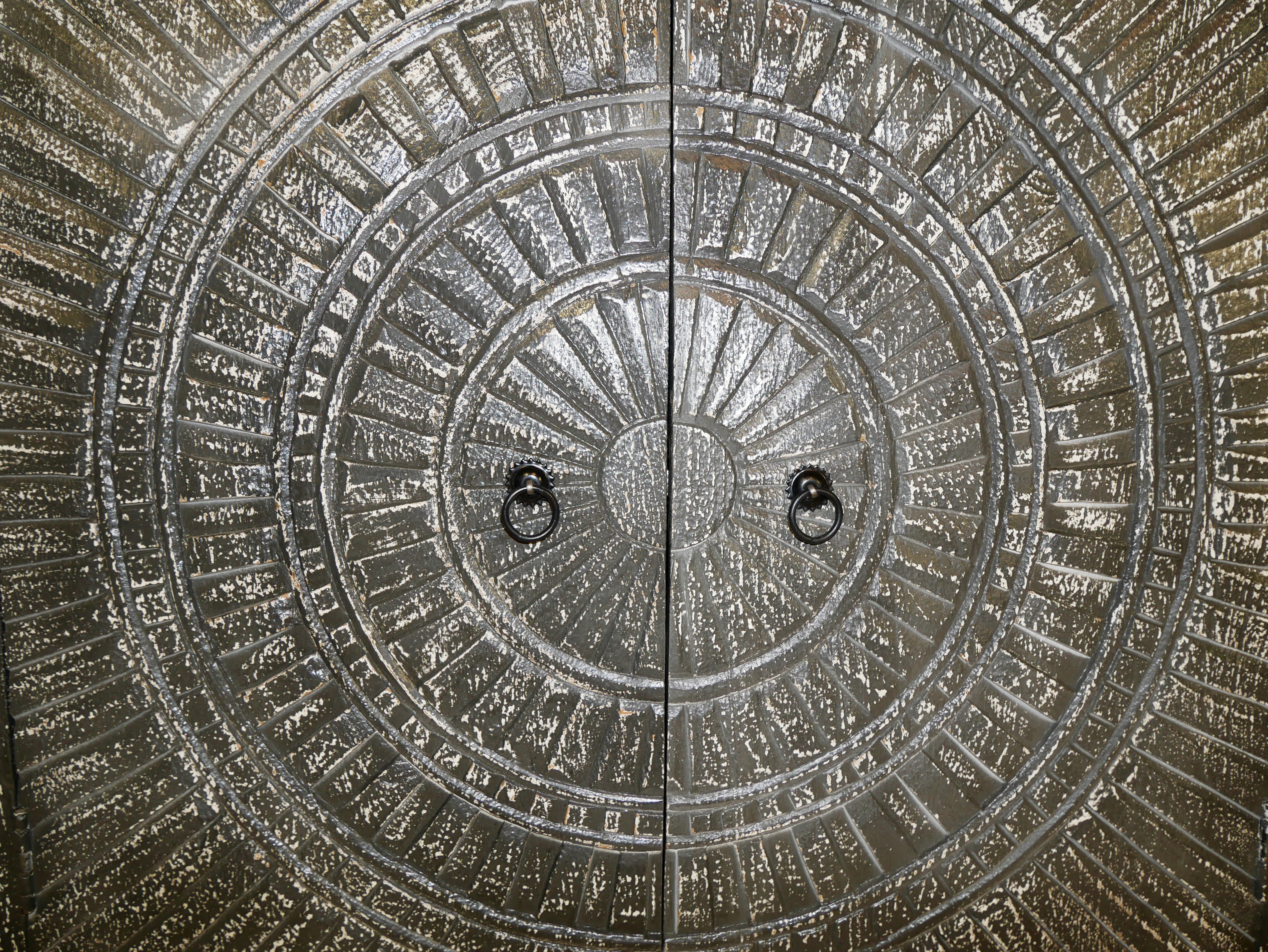 Close up image of a handcrafted carved wood sideboard made from mango wood with Indian motifs; ideal living room furniture, 170 × 90 × 40 cm.