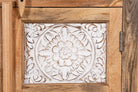 Close up image of a carved sideboard / bedroom furniture in mango wood with white-washed floral engravings, 90 × 40 × 100 cm.