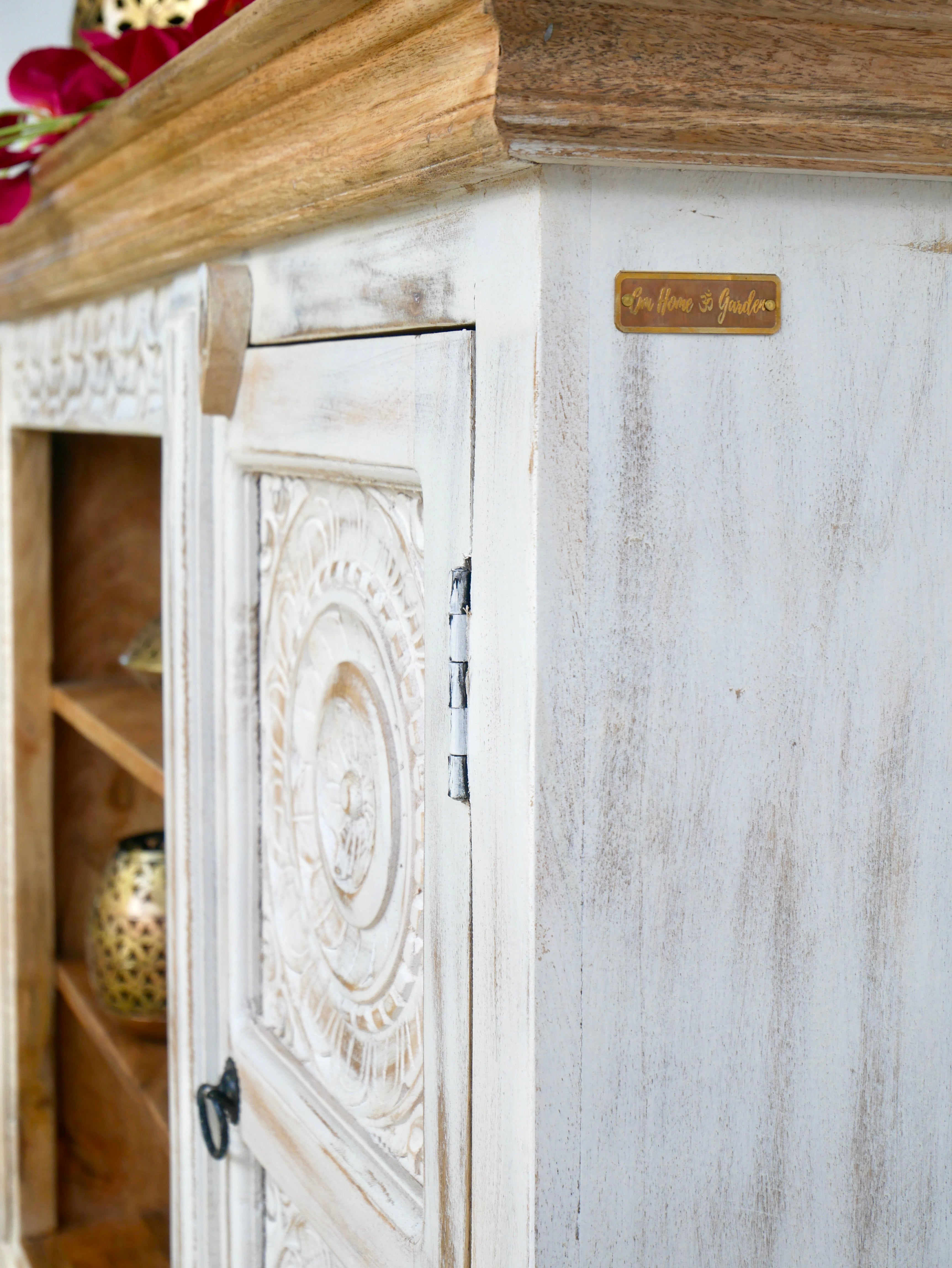 Close up image of a carved mango wood console table with Indian motifs and natural finish; vintage furniture with 3 compartments and 2 drawers, 150 × 75 × 40 cm.