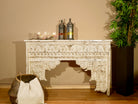 Whitewashed hand carved console table made from solid mango wood with floral detailing; mango wood console for vintage-inspired interiors, 140 × 40 × 91 cm.