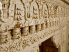 Close up image of a whitewashed hand carved console table made from solid mango wood with floral detailing; mango wood console for vintage-inspired interiors, 140 × 40 × 91 cm.