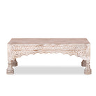 White background image of a Dhola handcrafted solid mango wood coffee table with intricately hand-carved floral patterns, natural wood grain, and artisan craftsmanship, 120cm.