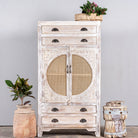 Handcrafted mango wood cabinet with rattan doors and carvings, living room furniture in whitewashed finish, 80 × 148 × 40 cm.
