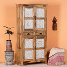 Side angle image of a hand-carved wooden wardrobe made from mango wood with whitewashed floral carvings; perfect as bedroom furniture, 90 × 180 × 40 cm.