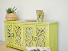 Side angle image of a Green Star hand carved mango wood sideboard with floral carvings and mirrored glass doors 180cm