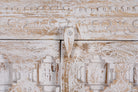 Close up image of a handcrafted cabinet made from reclaimed wood with white-washed finish and Indian carvings – sustainable furniture and unique Indian furniture with cultural depth.