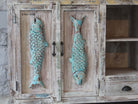 Close up image of a Jhund hand carved mango wood sideboard with blue fish motif doors 184cm