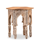 White background image of a hand carved mango wood coffee table with floral pattern, striking layered colour and vintage charm. A unique wooden accent for your home.