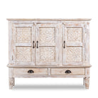 White background image of a whitewashed hand carved wooden sideboard made from solid mango wood with floral patterns, 3 doors and 2 drawers; artisanal mango wood furniture, 120 × 100 × 40 cm.