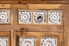 Close up image of a hand-carved mango wood sideboard with whitewashed floral details; perfect as living room furniture or mango wood furniture for vintage interiors, 180 × 100 × 40 cm.