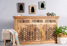 Side angle image of a hand-carved mango wood sideboard Kaveri with 6 compartments and 3 drawers, oriental-inspired mango wood furniture, 150 × 90 × 40 cm.