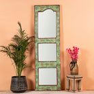 Painted wooden mirror Keshod made from recycled teak wood with hand-painted detailing. A sustainable furniture piece perfect for boho chic living room decor.