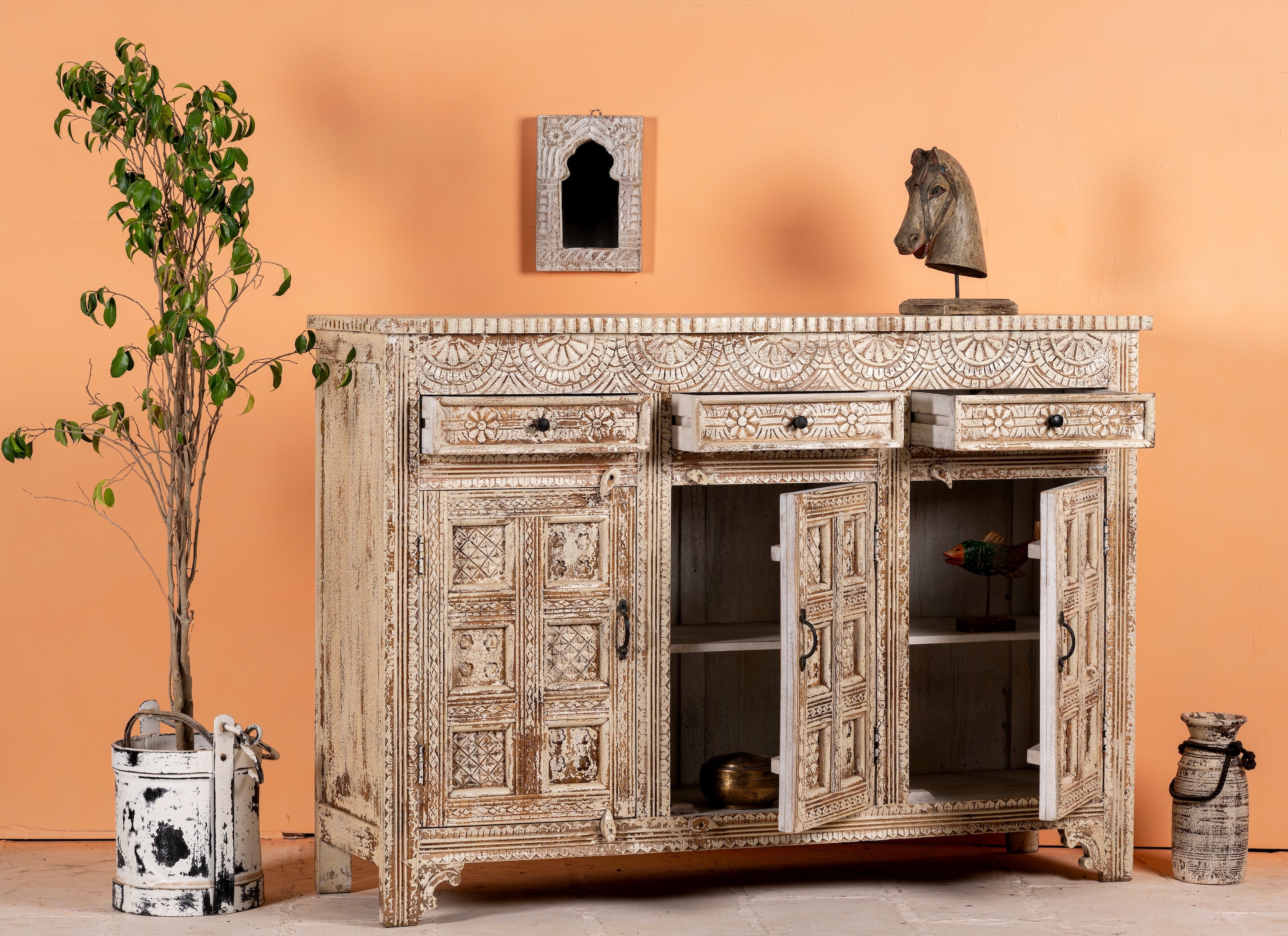 Open drawer image of a hand-carved mango wood cabinet with three drawers and vintage distressed finish; ideal for mango wood furniture lovers and vintage home decor, 150 × 110 × 40 cm.