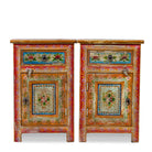 White background image of a set of two hand painted bedside tables with floral motifs; sustainable furniture made of recycled wood, 45 × 35 × 70 cm.
