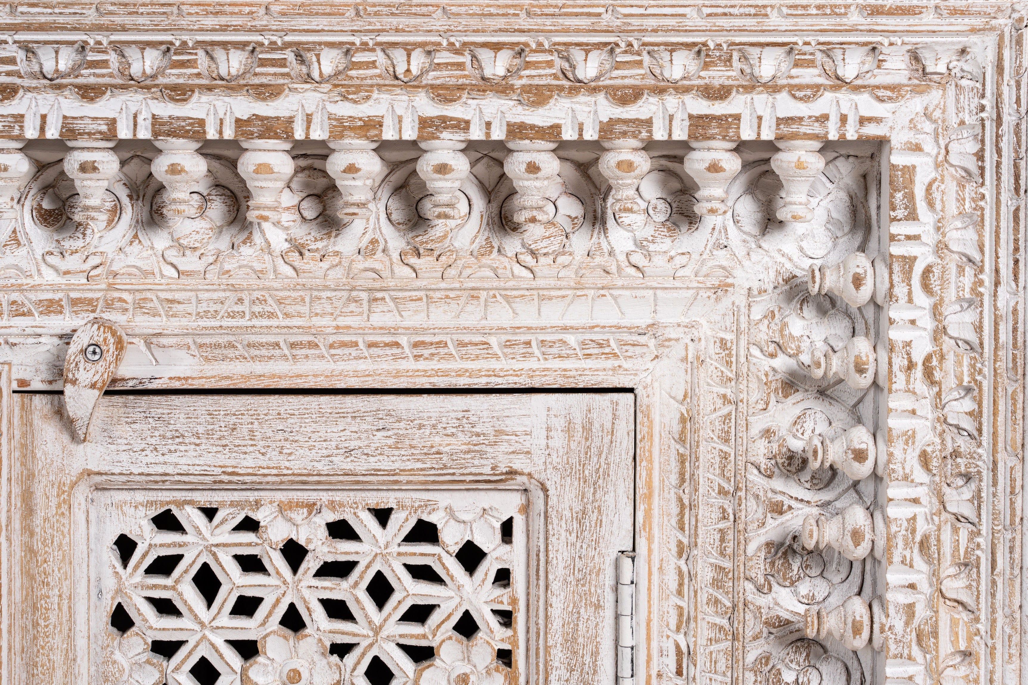 Close up image of a Rajula handcrafted solid mango wood sideboard with hand-carved floral doors, whitewashed finish, four spacious storage compartments, and traditional Indian craftsmanship, 180cm.