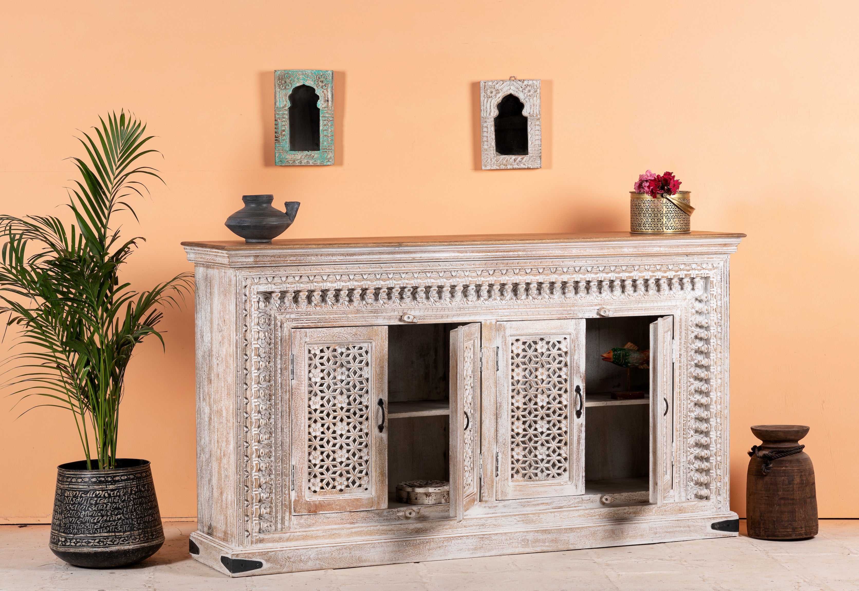 Side angle image with open doors of a Rajula handcrafted solid mango wood sideboard with hand-carved floral doors, whitewashed finish, four spacious storage compartments, and traditional Indian craftsmanship, 180cm.