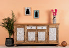 Lifestyle image of a Talaja handcrafted solid mango wood sideboard with intricately hand-carved doors, natural wood grain, traditional Indian patterns, and spacious storage, 180cm.