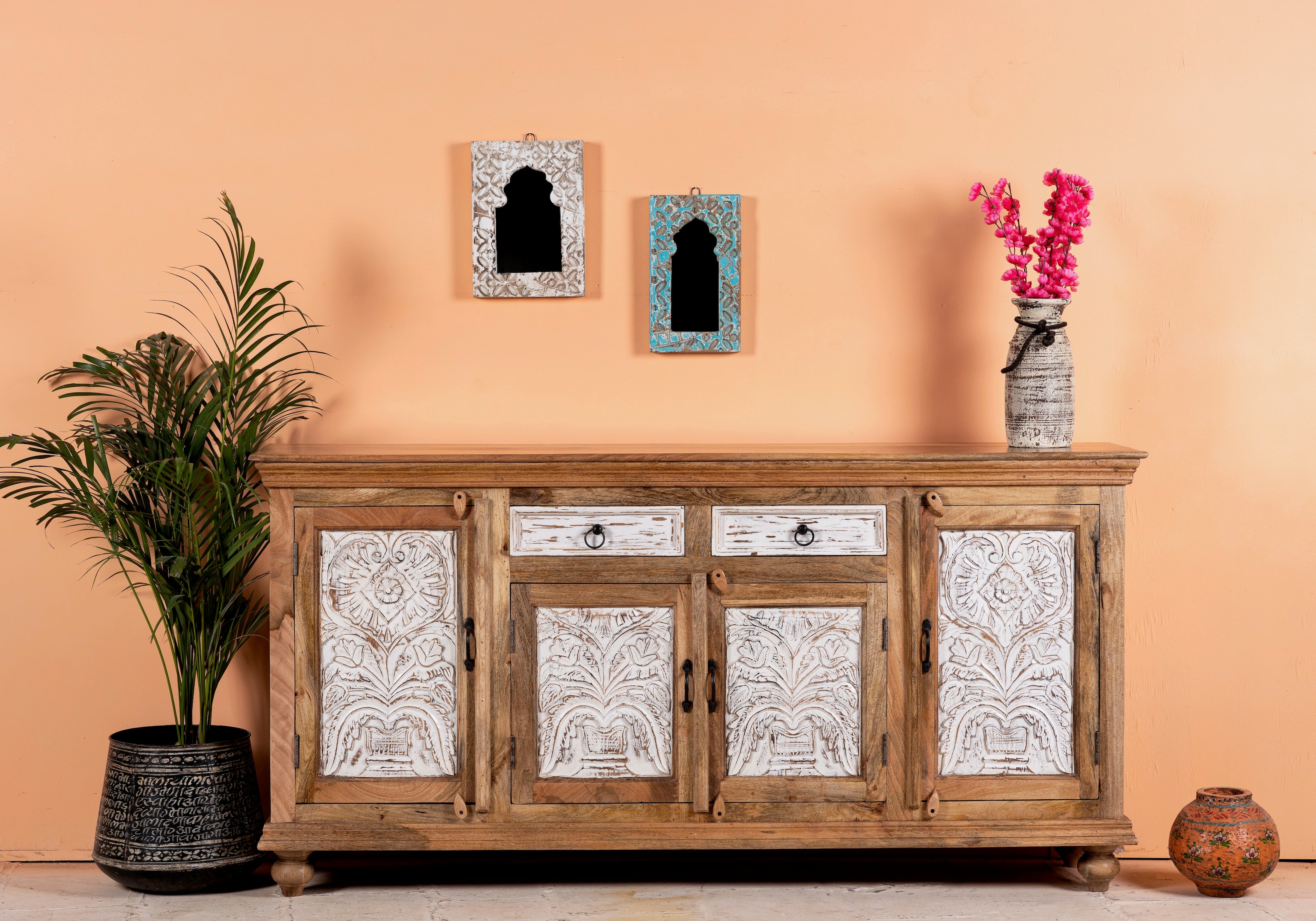 Lifestyle image of a Talaja handcrafted solid mango wood sideboard with intricately hand-carved doors, natural wood grain, traditional Indian patterns, and spacious storage, 180cm.